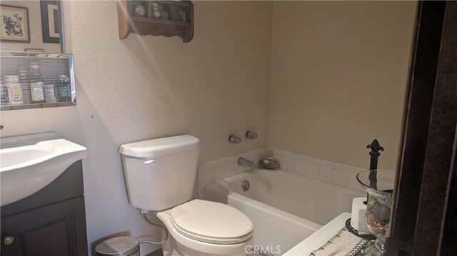 bathroom featuring vanity, toilet, and a bathtub