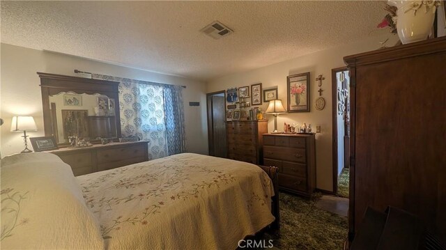 bedroom with carpet and a textured ceiling