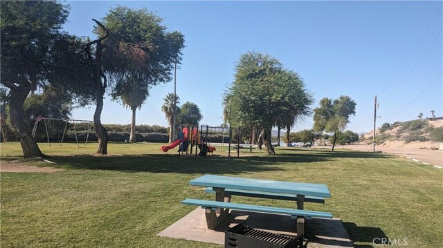 surrounding community with a lawn and a playground