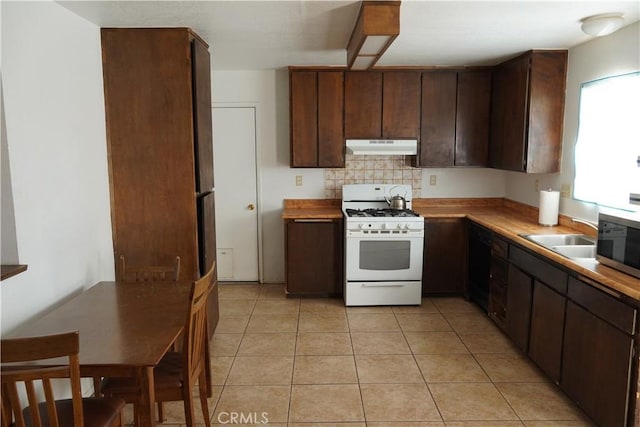 kitchen with sink, light tile patterned floors, gas range gas stove, dark brown cabinetry, and decorative backsplash