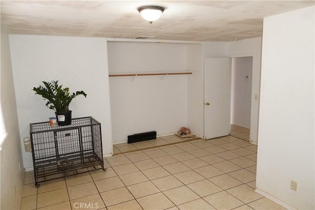 tiled bedroom featuring a closet