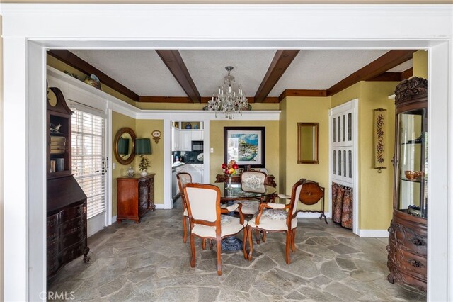 dining space featuring beam ceiling and a chandelier