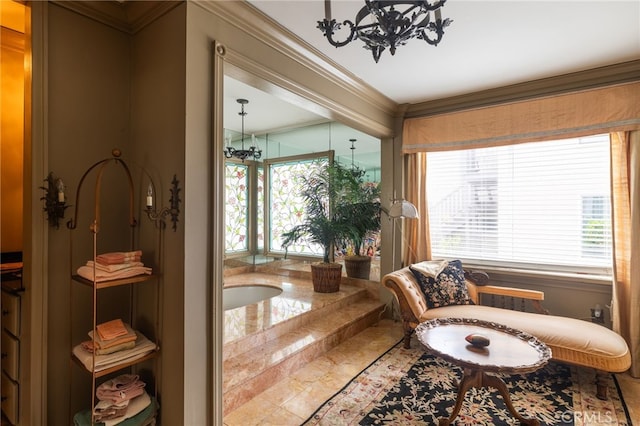 living area with crown molding and a chandelier