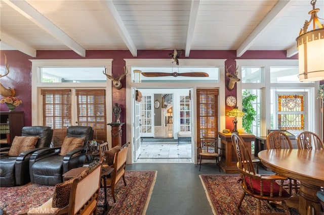 dining space with beam ceiling