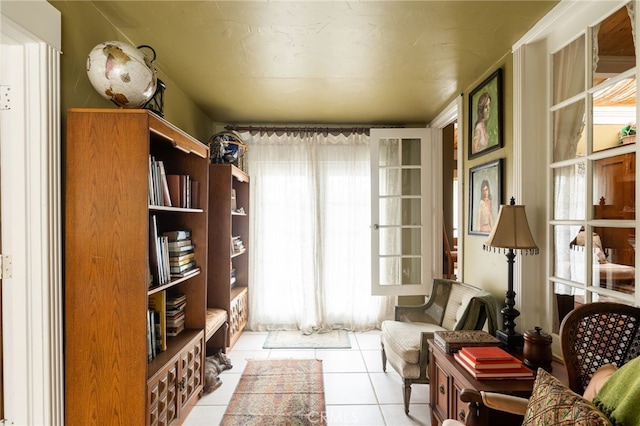 living area featuring a healthy amount of sunlight and light tile patterned flooring