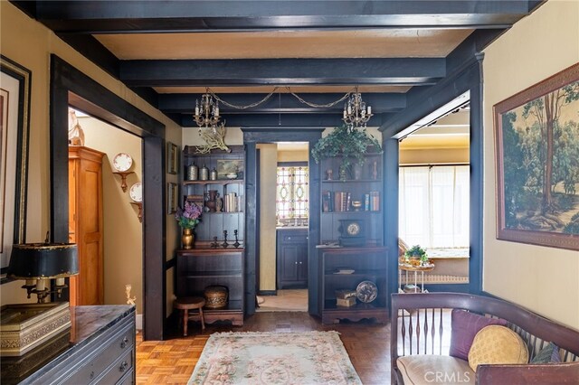 interior space featuring parquet floors, a chandelier, and beamed ceiling