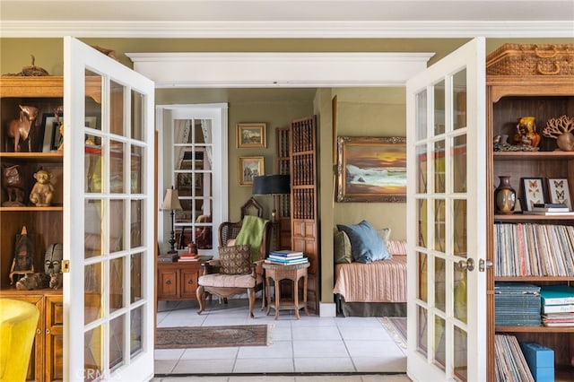 interior space featuring light tile patterned floors, french doors, and crown molding