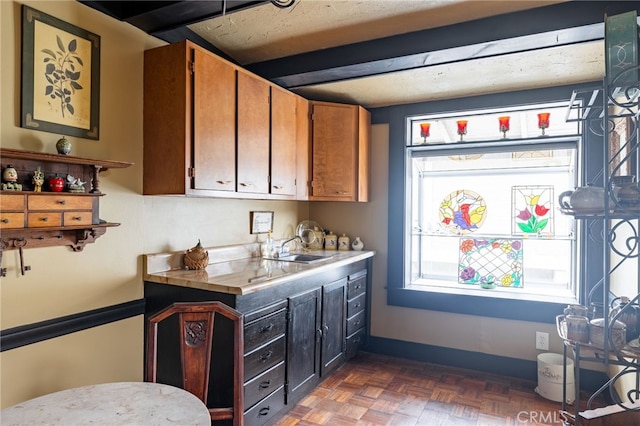 kitchen with sink and dark parquet floors