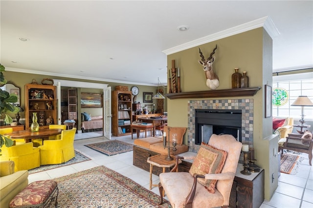 living room with light tile patterned floors, a tile fireplace, and ornamental molding