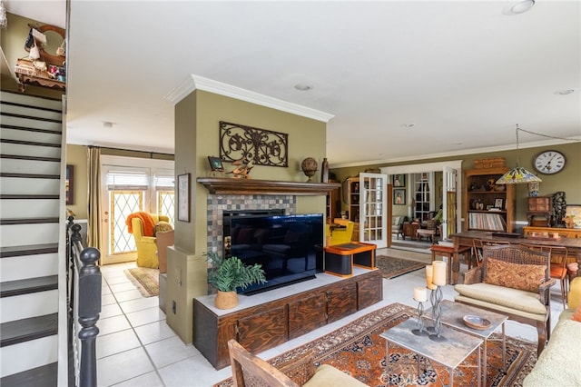 tiled living room with a tiled fireplace, crown molding, and french doors