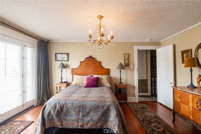 bedroom featuring multiple windows, ornamental molding, and a textured ceiling