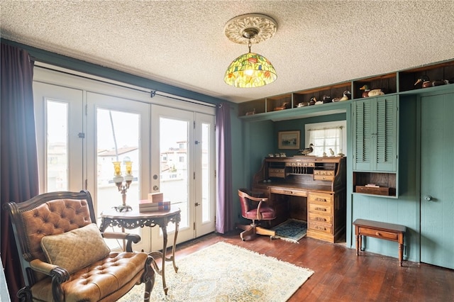 interior space featuring a textured ceiling, dark wood-type flooring, and french doors