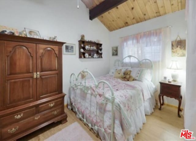 bedroom with lofted ceiling with beams, light hardwood / wood-style floors, and wood ceiling