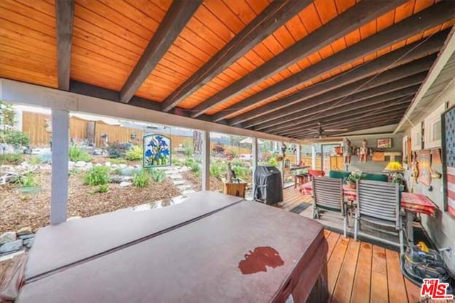 deck featuring a jacuzzi and grilling area