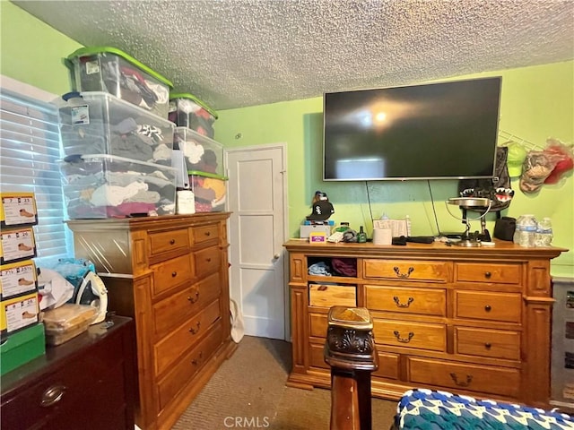 carpeted bedroom featuring a textured ceiling