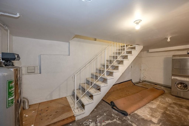 basement featuring stacked washer and clothes dryer