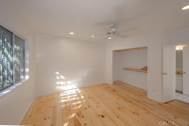 interior space with light hardwood / wood-style floors, a closet, and ceiling fan