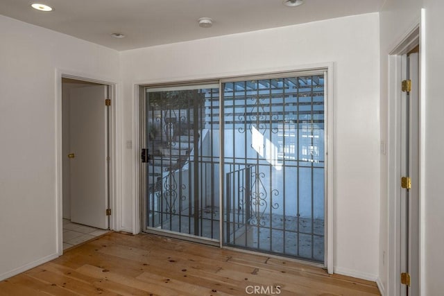 doorway with light wood-type flooring