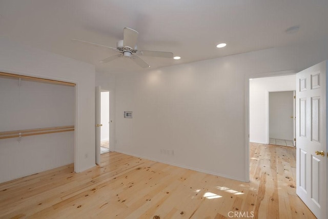 unfurnished room featuring ceiling fan and light wood-type flooring