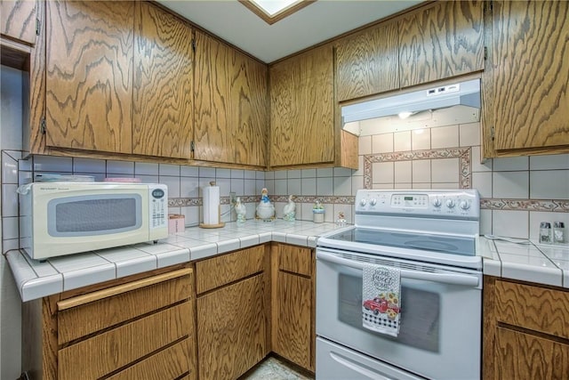 10 Royale Ave Unit 13A-2, Lakeport, CA 95453 - kitchen with tile countertops, white appliances, under cabinet range hood, and brown cabinets