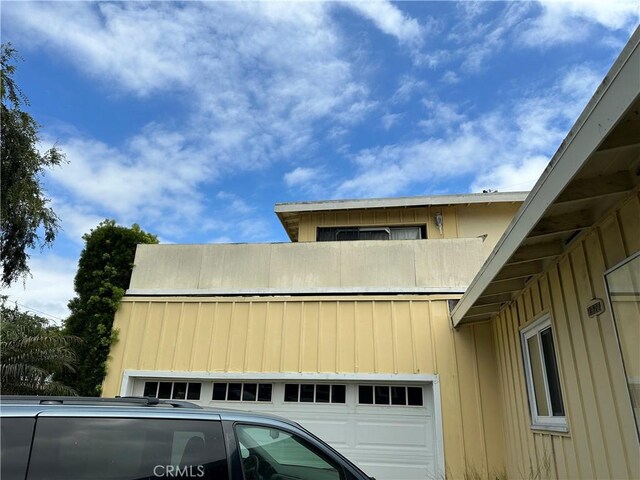2922 Radnor Ave, Long Beach, CA 90815 - view of side of property featuring a garage and board and batten siding