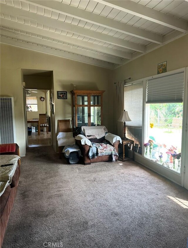 2922 Radnor Ave, Long Beach, CA 90815 - living room with carpet floors, lofted ceiling with beams, and a heating unit