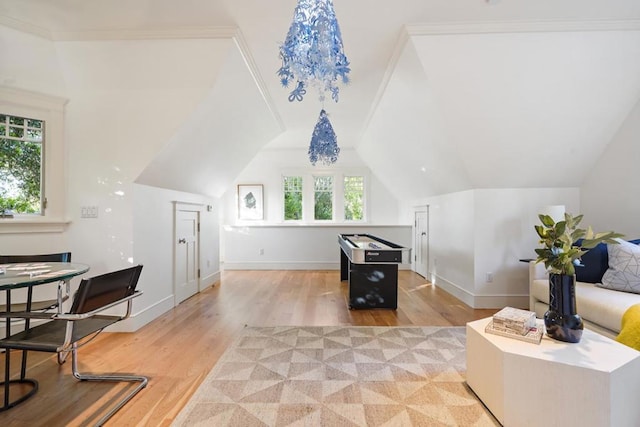 additional living space with lofted ceiling and light hardwood / wood-style flooring