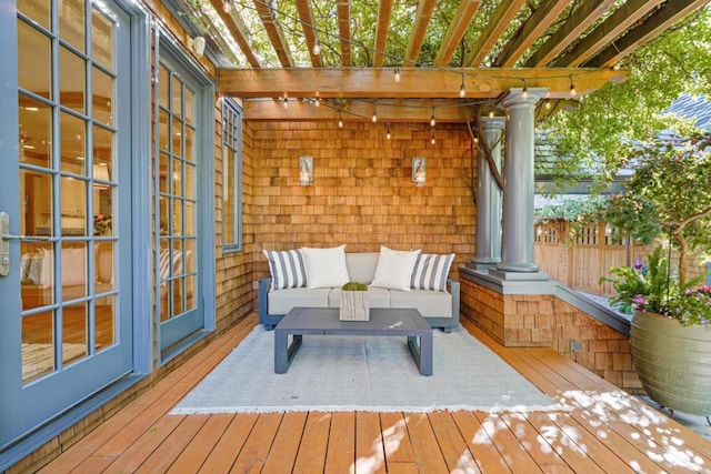 wooden deck with a pergola and outdoor lounge area