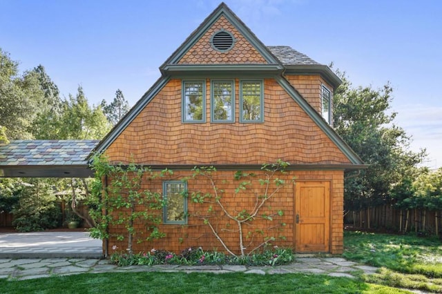 view of property exterior with a lawn