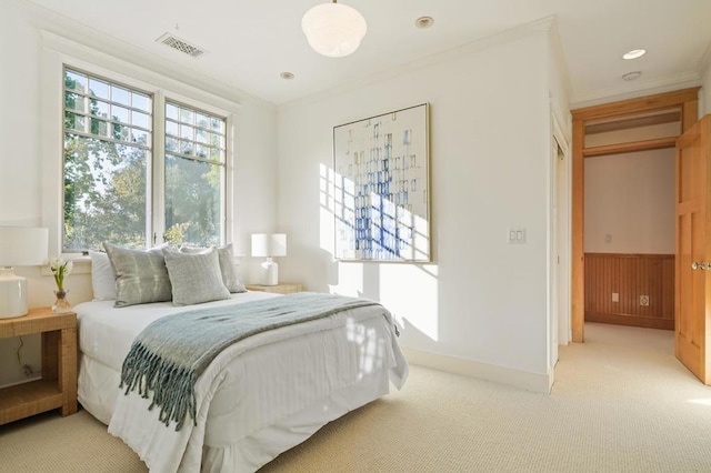 carpeted bedroom featuring ornamental molding and wooden walls