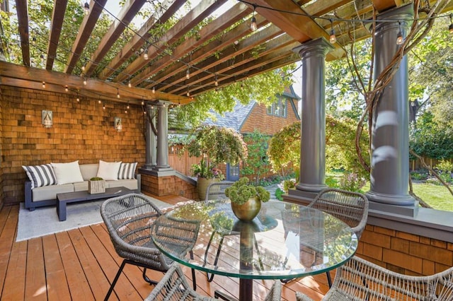 wooden terrace with a pergola and outdoor lounge area