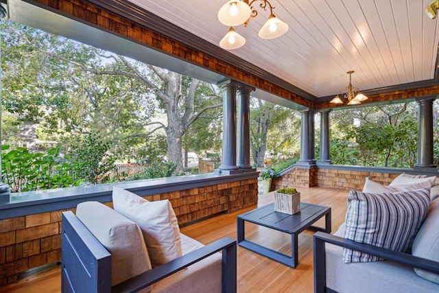 sunroom / solarium with an inviting chandelier