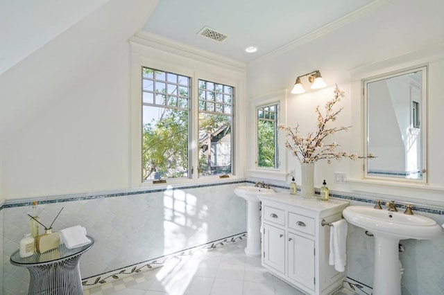 bathroom featuring sink, tile walls, tile patterned floors, and crown molding