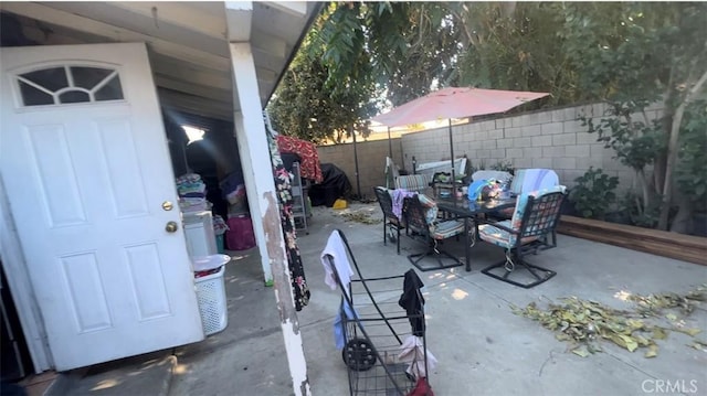 view of patio with outdoor dining space and a fenced backyard