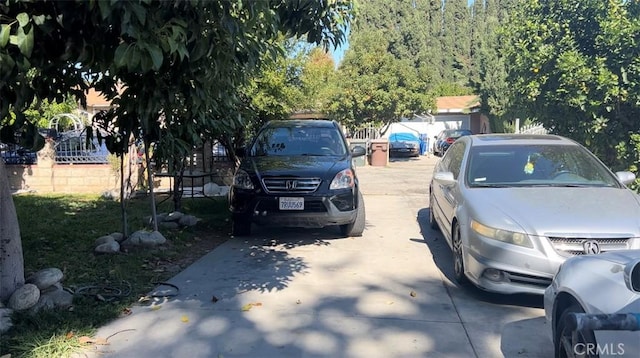 view of car parking featuring fence