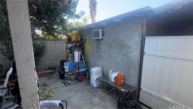 view of side of property featuring a patio area and fence