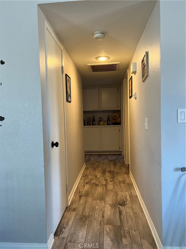 corridor featuring hardwood / wood-style floors