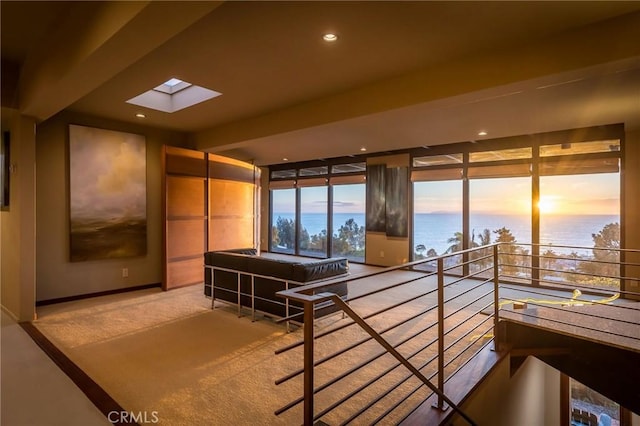 interior space featuring carpet flooring and a water view