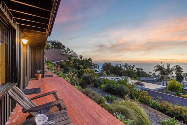 exterior space with a water view and a patio