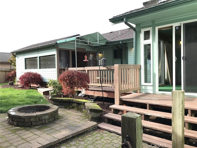 view of patio / terrace with an outdoor fire pit and a wooden deck