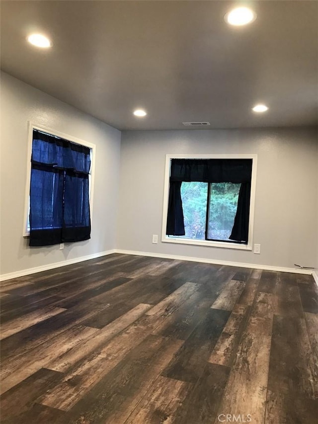 spare room featuring dark wood-type flooring