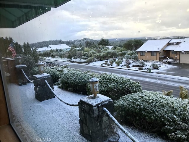 view of snow covered back of property