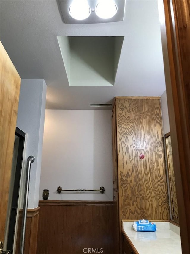 bathroom featuring wood walls