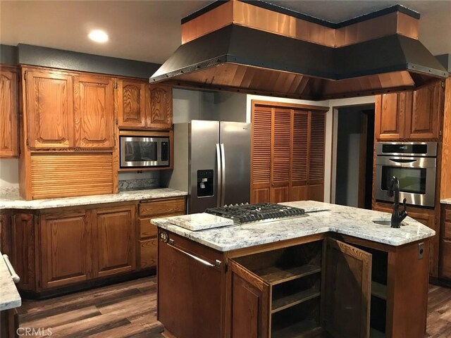 kitchen with stainless steel appliances, a kitchen island, dark hardwood / wood-style floors, and island range hood