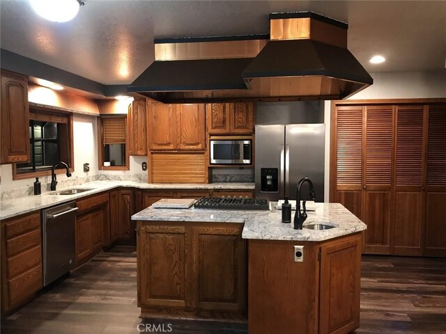 kitchen with a center island, sink, appliances with stainless steel finishes, and island range hood