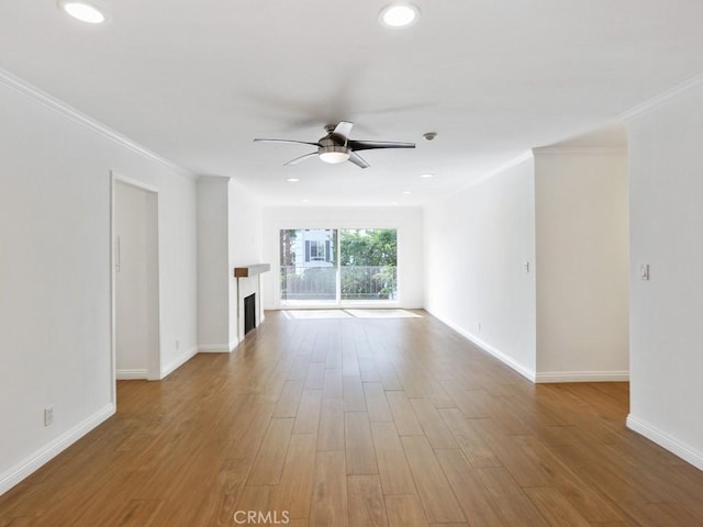 unfurnished living room with ceiling fan, ornamental molding, and hardwood / wood-style floors