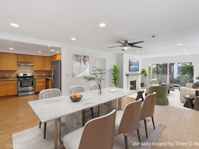 dining area with ceiling fan, light hardwood / wood-style flooring, and ornamental molding