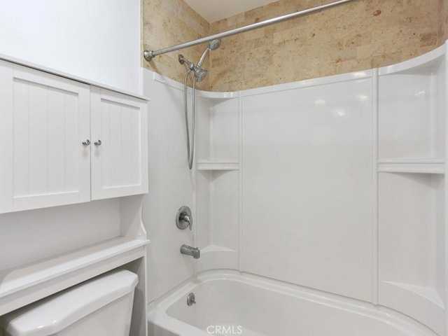 bathroom featuring shower / bath combination and toilet