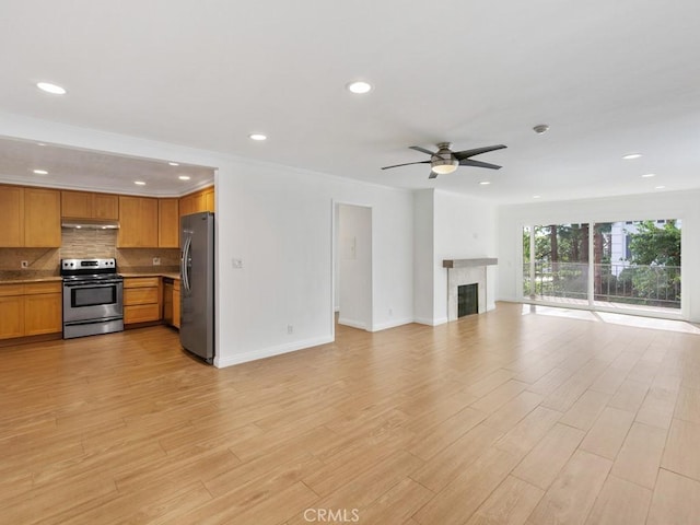 unfurnished living room with ceiling fan, light hardwood / wood-style floors, and crown molding