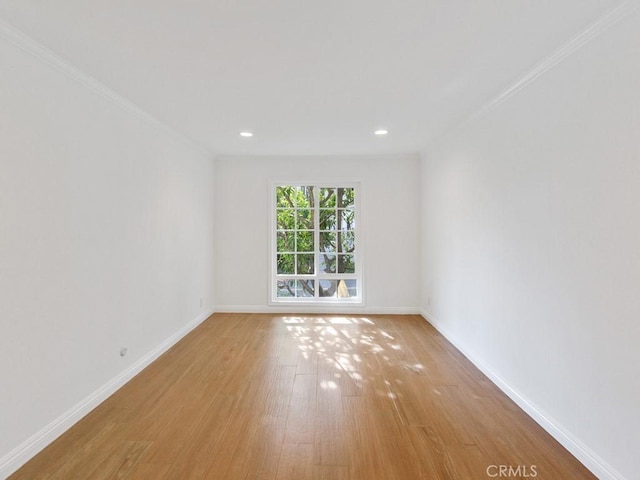 unfurnished room with light hardwood / wood-style flooring and crown molding